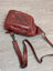 Red Ajax sling bag in distressed wax pull-up leather with adjustable strap
