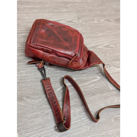 Red Ajax sling bag in distressed wax pull-up leather with adjustable strap
