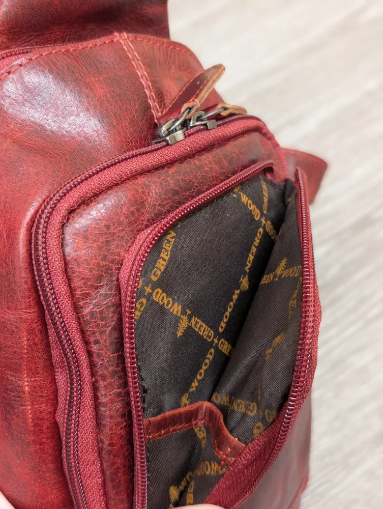 Red Ajax sling bag in wax pull-up leather with green + wood gold lining