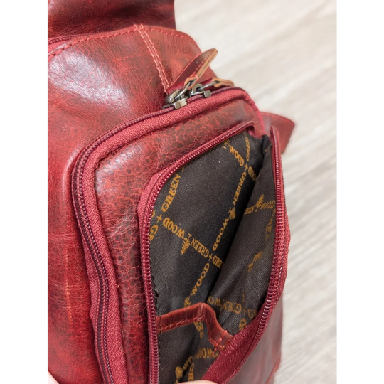 Red Ajax sling bag in wax pull-up leather with green + wood gold lining