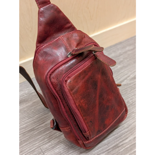Red wax pull-up leather Ajax sling bag with distressed texture and stitching
