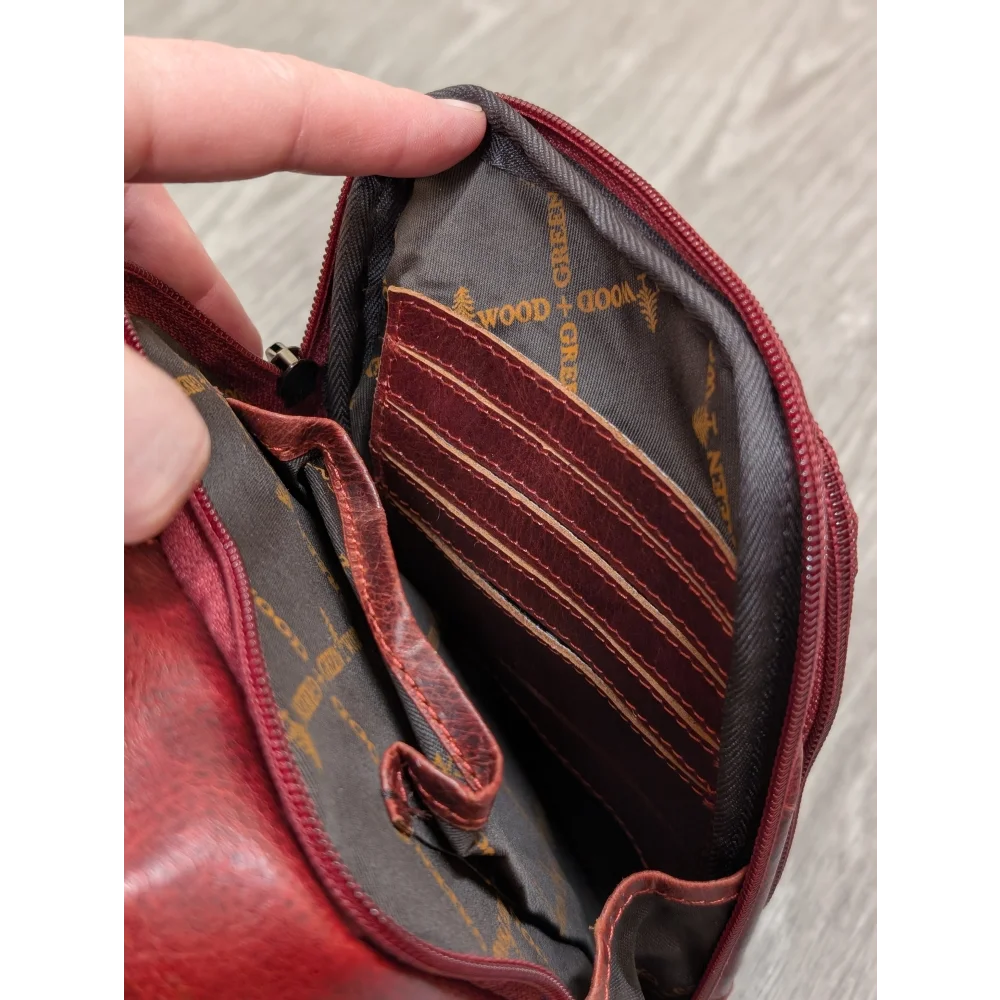 Red wax pull-up leather Ajax sling bag with gray interior and gold branding