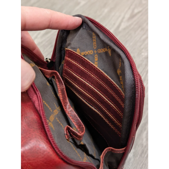 Red wax pull-up leather Ajax sling bag with gray interior and gold branding