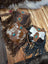 Three mojave tassel bags in rich hunter leather with cowhide patterns flowing fringe and turquoise stone accents