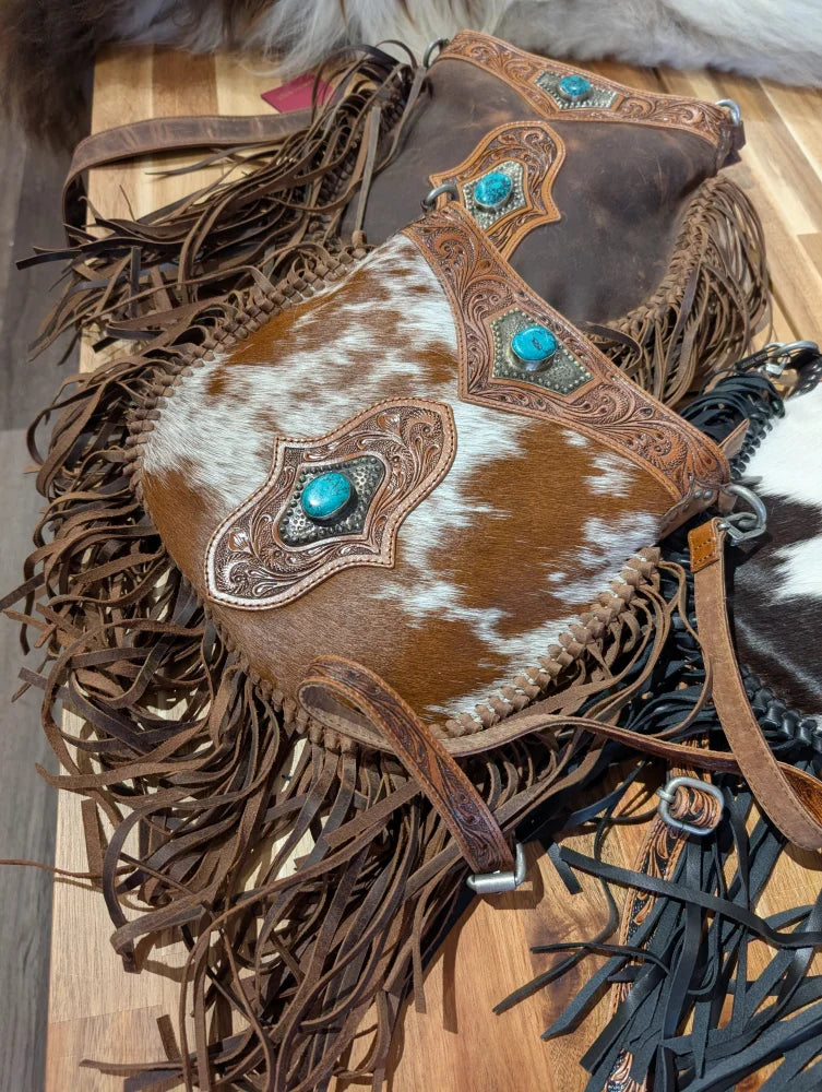 Brown and white mojave tassel bag with rich hunter leather, turquoise inlays, and flowing fringe free when you spend 500 plus