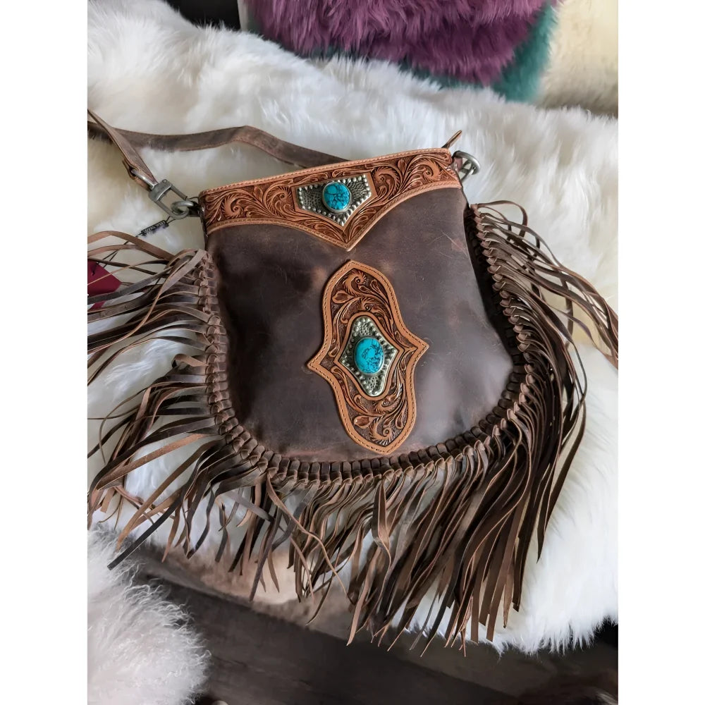 Brown leather mojave tassel bag with intricate tooled designs, turquoise stone accents, and flowing fringe in rich hunter leather