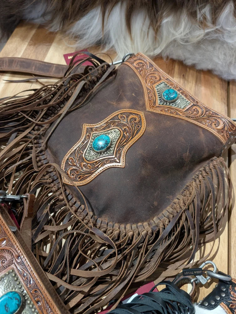 Brown leather mojave tassel bag with rich hunter leather, flowing fringe, intricate tooled designs, and turquoise accents