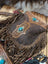 Brown leather mojave tassel bag with rich hunter leather, flowing fringe, intricate tooled designs, and turquoise accents