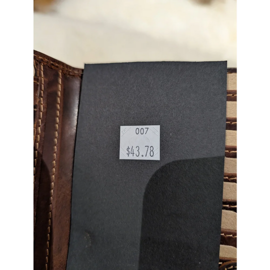 Angus Oliver black sheepskin leather wallet with white price tag
