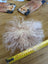 Curly blonde wig with yellow tape on light pink sheepskin pom pom by Angus Oliver