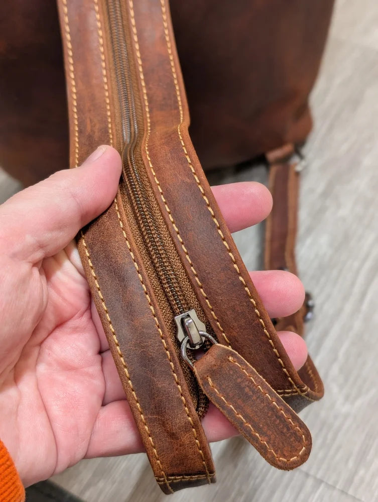 Brown leather shoulder bag strap with tan stitching on Leather Backpack GW006B