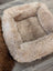 Cozy beige sheepskin pet bed with plush faux fur lining