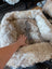Cozy beige and brown highland sheepskin pet bed with plush faux fur interior
