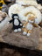 Cozy black and white plush cat on sheepskin pet bed