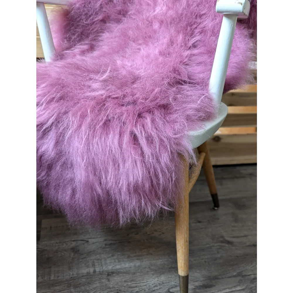 Lovely pink Icelandic sheepskin throw pillow with wooden legs
