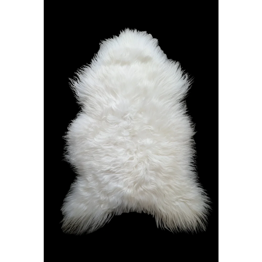 Natural white icelandic sheepskin rug with soft dense fur and irregular shape perfect for cozy home decor