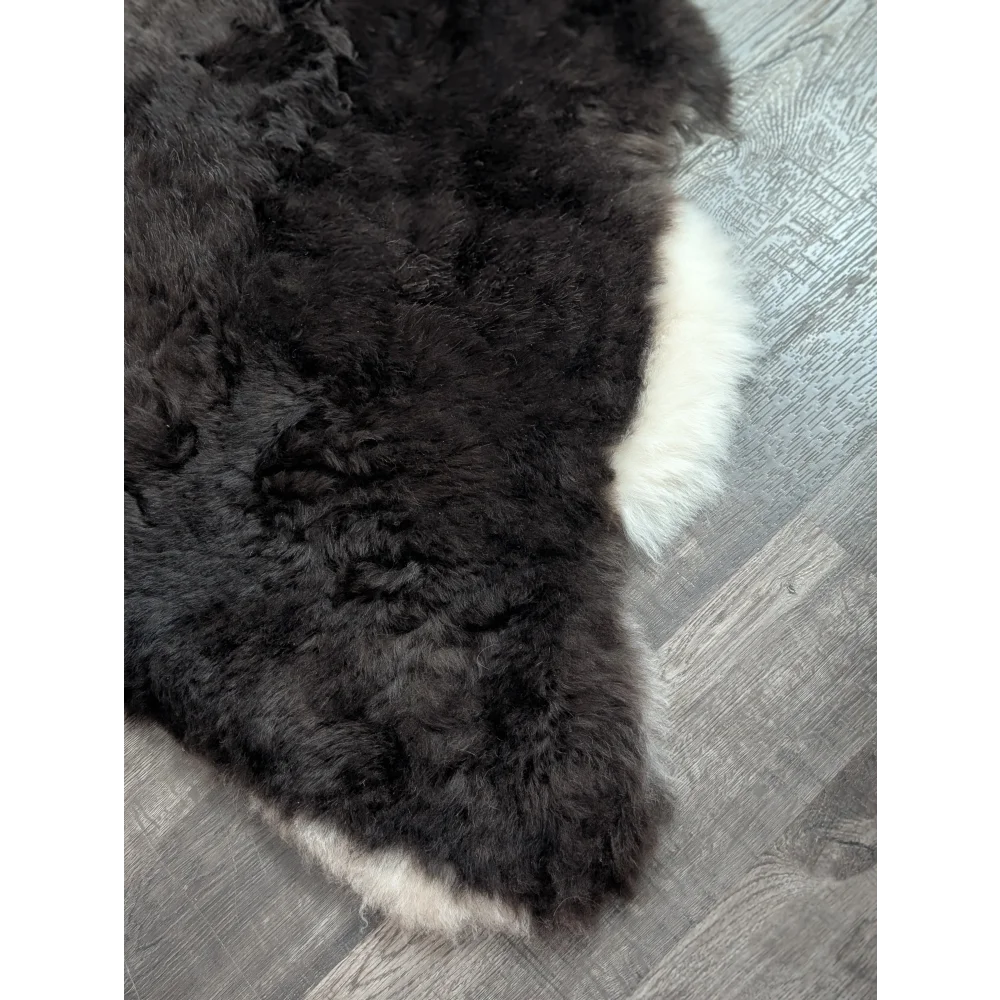 Black and white large soft luv10 icelandic sheepskin rug with plush short wool fur measuring 43.5 by 28.5 inches