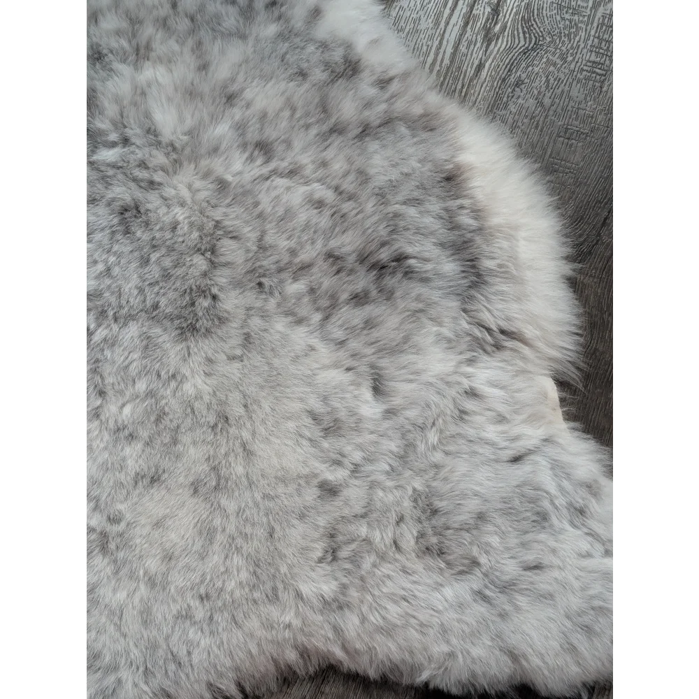 A plush gray large soft spotted icelandic sheepskin rug with natural texture and medium spotted icelandic wool