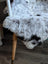 A plush large soft icelandic sheepskin rug with a white and black spotted pattern medium spotted icelandic style
