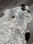 A plush large soft spotted icelandic sheepskin rug in white and black with medium spotted icelandic short wool