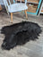 Black fluffy long wool icelandic sheepskin rug with natural irregular shape and dense soft wool icelandic fur