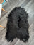 Large soft icelandic sheepskin rug in natural black with long wool and fluffy irregular edges for cozy decor