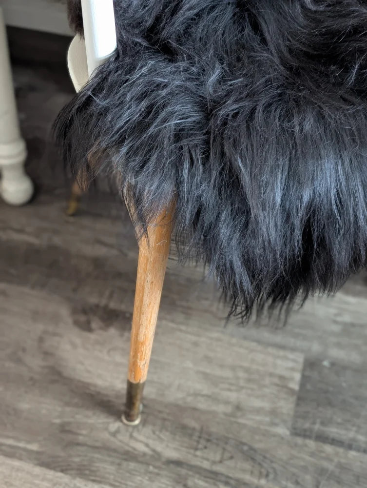 Large luv34 black faux fur chair with wooden legs and brass feet featuring soft wool icelandic sheepskin cover