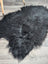 Black fluffy large soft icelandic sheepskin rug with long wool and natural irregular shape in black color