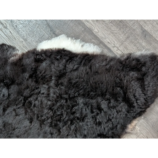 Large luv7 black icy icelandic sheepskin rug with short wool and white fluffy edge for cozy decor