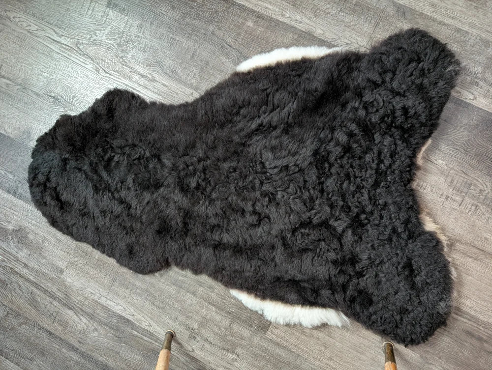 Black and white large soft luv8 icelandic sheepskin rug with curly plush short wool fur, 42 by 28 inches