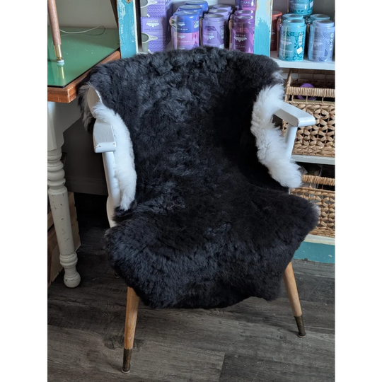 Luv9 large black sheepskin chair cover with white fur trim made from soft short wool icelandic sheepskin