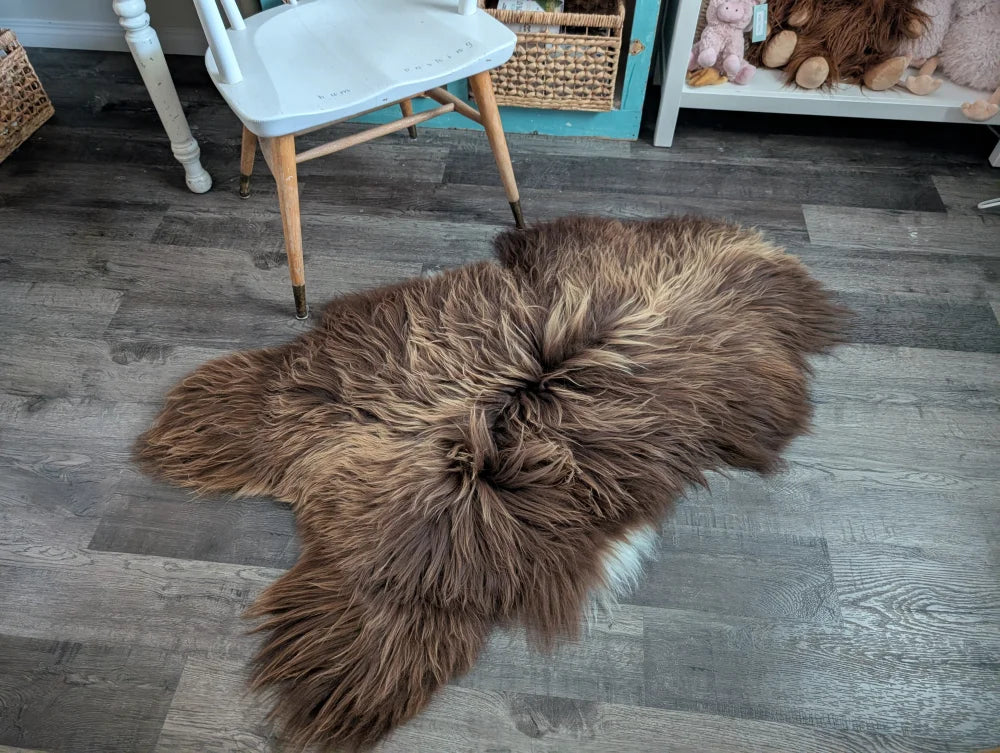 A plush brown long wool icelandic sheepskin rug with natural fluffy texture for cozy floor decor