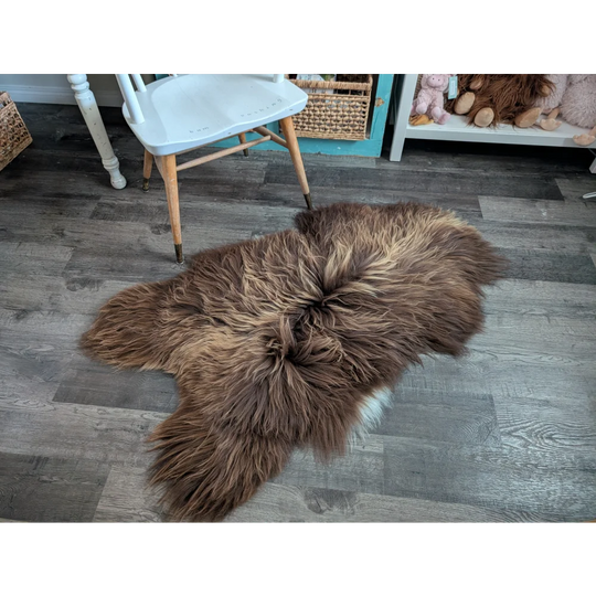 A plush brown long wool icelandic sheepskin rug with natural fluffy texture for cozy floor decor
