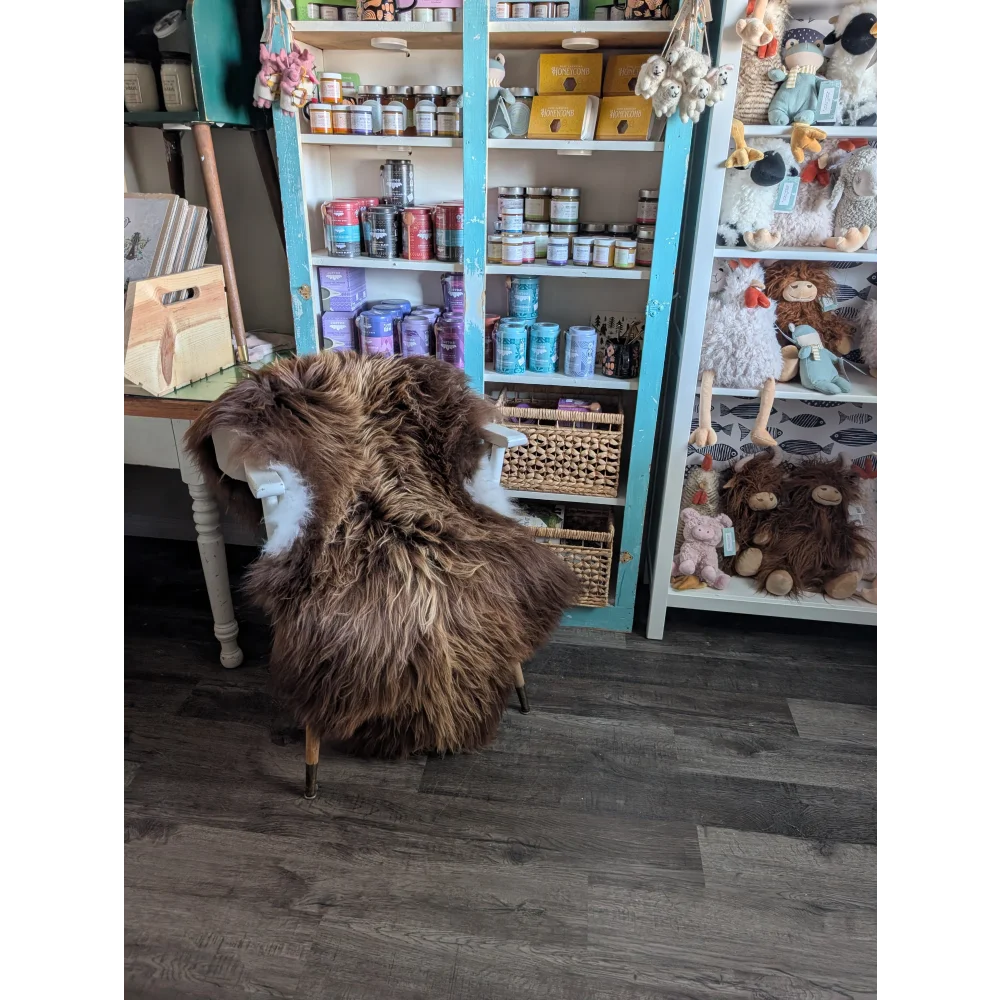 Brown fluffy luv44 icelandic sheepskin chair with white underbelly metal legs long wool icelandic bronze color