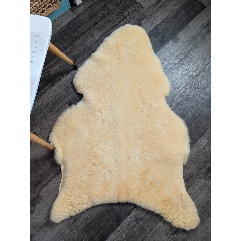 Cream-colored medical sheepskin rug with fluffy texture and irregular shape from angus oliver washable sheepskin rugs