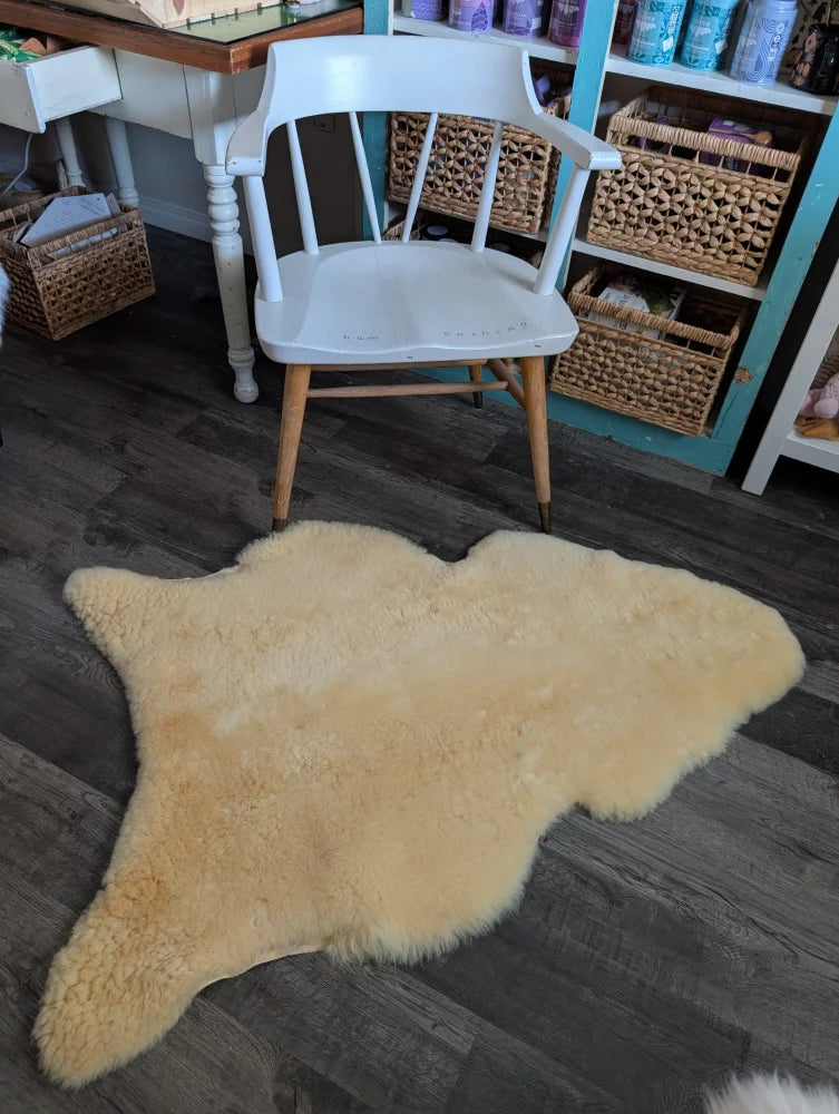 Cream-colored medical sheepskin rug with fluffy texture and irregular edges from angus oliver massive washable design
