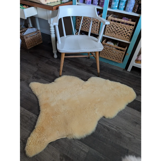 Cream-colored medical sheepskin rug with fluffy texture and irregular edges from angus oliver massive washable design