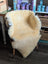 Cream-colored angus oliver medical sheepskin chair with wooden legs perfect for washable sheepskin rugs and cowhide rugs