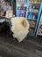 Cream-colored washable medical sheepskin chair with wooden legs by angus oliver for comfort and style