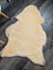 Cream-colored angus oliver medical sheepskin rug with fluffy texture and irregular edges perfect for sheepskin rugs fans