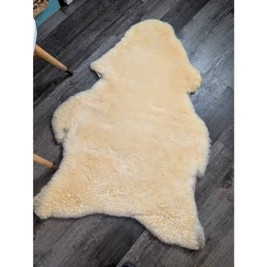 Cream-colored angus oliver medical sheepskin rug with fluffy texture and irregular edges perfect for sheepskin rugs fans