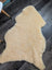 Cream-colored angus oliver massive washable medical sheepskin rug with soft fluffy texture and natural edges