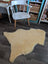 Cream-colored washable medical sheepskin rug with fluffy texture and natural edges by angus oliver for cozy use