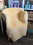 Cream-colored extra large washable medical sheepskin chair with soft fluffy texture and wooden legs by angus oliver