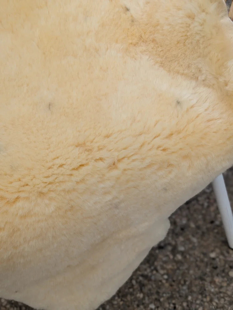 Cream-colored plush naturally spotted medical sheepskin rug 49 x 32 extra large washable for medical use