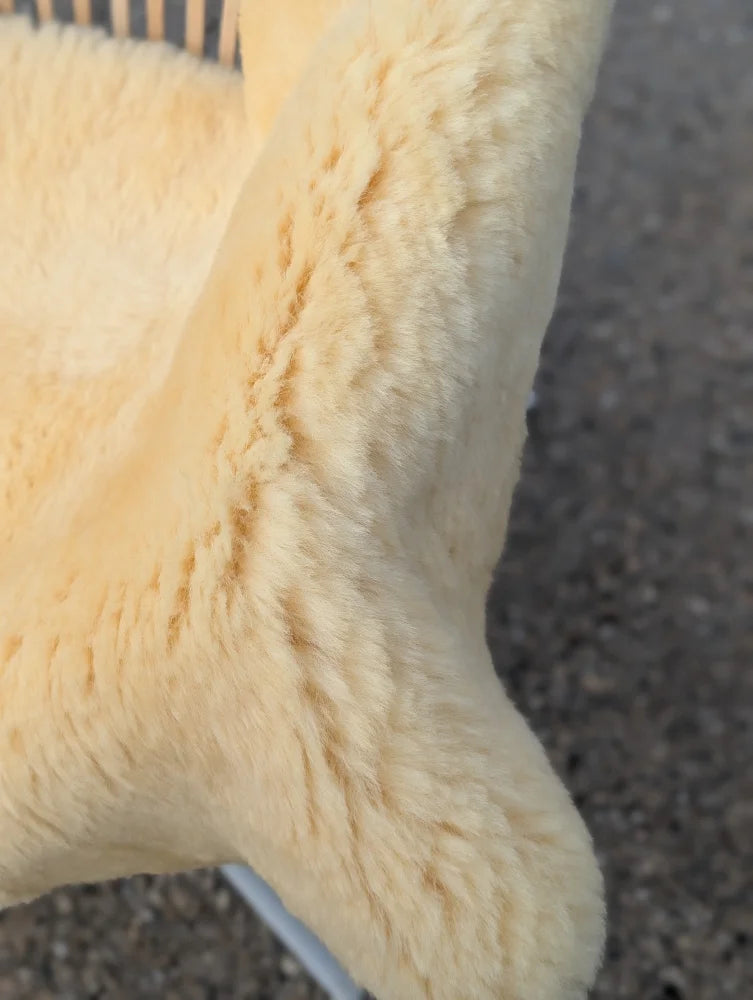 Cream-colored plush medical sheepskin with soft fluffy texture for extra large washable m-11 51 x 33 use