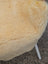 Cream-colored plush sheepskin chair with white metal legs featuring large washable naturally spotted medical sheepskin