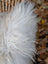 A fluffy white faux fur coat with long wool icelandic strands and plush texture in natural grey color