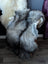 A thick natural long wool icelandic grayish silver sheepskin rug draped over the back of a white chair