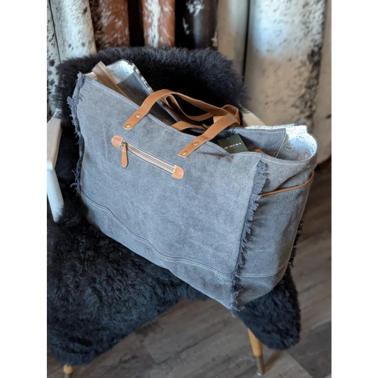 Matty Affair canvas hair on weekender bag with gray tote frayed edges